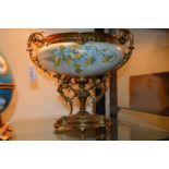 A French porcelain centrepiece painted with flowers on an ivory ground, with ormolu mounts, 26cm