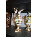 A German porcelain ewer encrusted with flowers, 35cm high