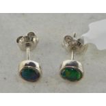 Black opal stud earrings, oval cabochon cut opals, measuring approximately 4mm in length, mounted in