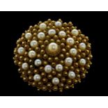 Ornate pearl wire work brooch, central white round pearl surrounded by two rows, with a total of