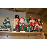 A collection of modern brightly painted peg dolls and a model Christmas tree ornament
