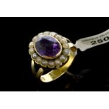 Amethyst and seed pearl ring, central oval cut amethyst, surrounded by white seed pearls, mounted in