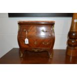 A 19th century French apprentice's chest of drawers of bombé shape, the drawers and sides with