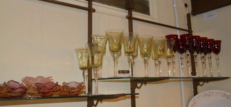 A set of 12 long stemmed pale green glasses; a set of 11 long stemmed red wine glasses; a set of