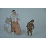 An early 20th century bisque brown doll's house doll, with fixed brown eyes, on five piece bisque