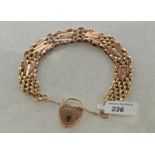 9ct yellow gold fancy link gate bracelet, padlock clasp with floral engraving and safety chain,