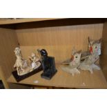 A collection of figurines: boy taking photo of a girl; golfer book end; carved painted owls (4)