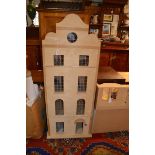 A Domat doll's house modelled as a Georgian town house, 114 x 45 x 31cm; a doll's house modelled