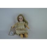 A Heubach Koppelsdorf 250 bisque headed doll with sleeping blue eyes, open mouth with four teeth,