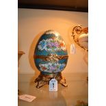 *A Limoges porcelain egg painted with flowers in Sèvres style on a turquoise pebble ground