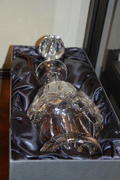 A Waterford glass decanter; a vase with etched floral design; matching bowl and other items of
