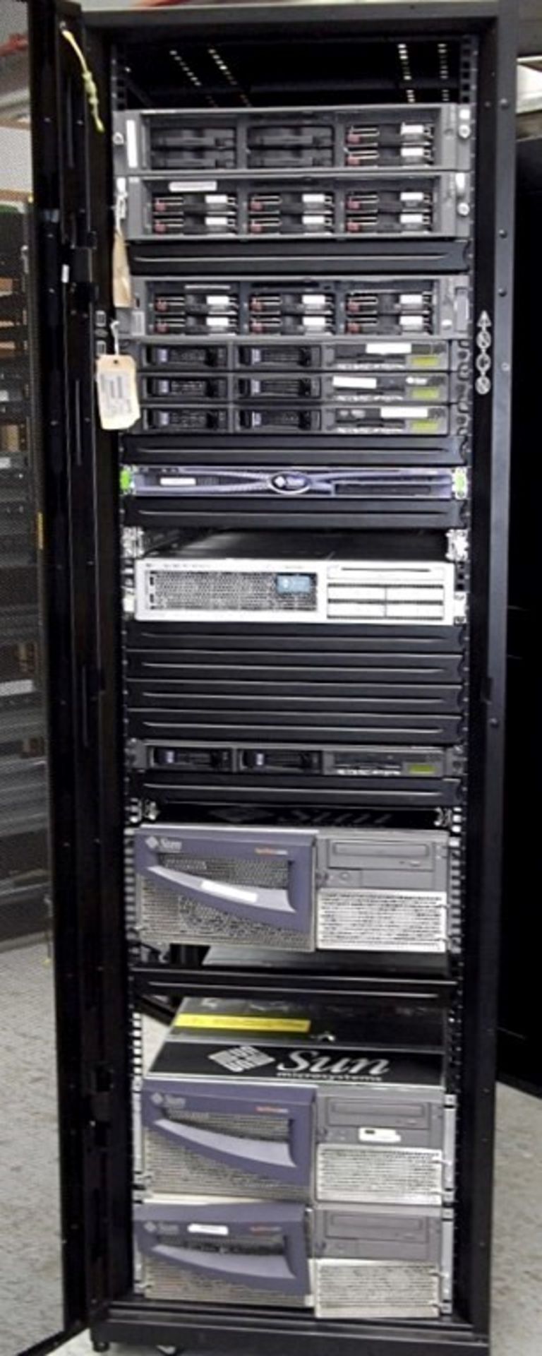 1 x APC Netshelter Server Rack With 12 x Assorted Sun Fire & HP Proliant Filer Systems Including