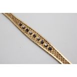 Bracciale in oro giallo 9kt in maglia, impreziosito da quattro diamanti taglio brillante ct 0,20 e