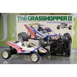 Two 1/10th scale Tamiya "Grass Hoppers" off road racers
