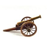 A hand made brass and wooden model of a Worlitzer cannon in display case