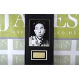 A framed and mounted Frankie Howard photo with signed white card mounted below
