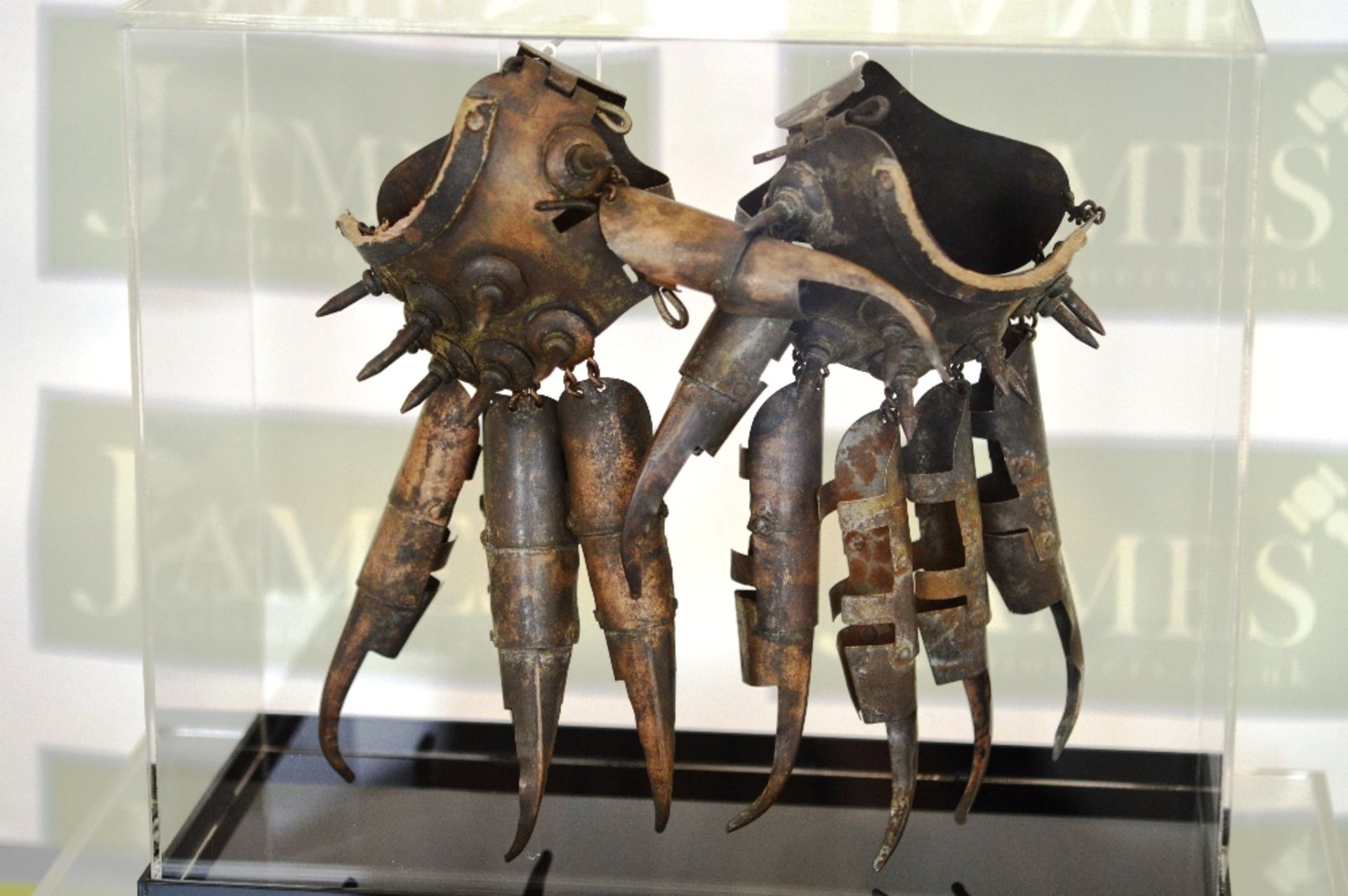 A pair of metal spiked Japanese fighting gloves, signs of use..comes in display case