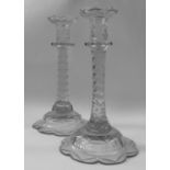 A pair of 19th century cut glass candlesticks raised on petal shaped bases.