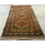 A brown patterned geometric design woollen rug, 1.91 x 1.13m.