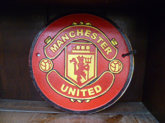 Two cast metal circular football wall plaques for Manchester United and Chelsea.