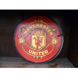 Two cast metal circular football wall plaques for Manchester United and Chelsea.