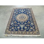 A blue ground floral patterned woollen rug and one other similar, both 1.30 x 0.89m.