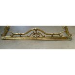 An ornate Victorian brass fire curb.