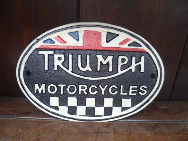 A cast metal reproduction wall sign for Triumph motor cycles.