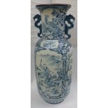 A large impressive two handled floor standing blue and white vase decorated with panels depicting