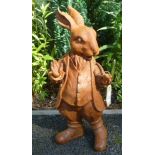 A cast metal rust effect garden ornament of a standing rabbit.