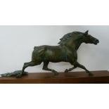 A bronzed spelter figurine of a running horse with presentation plaque in German.