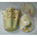A pair of floral decorated moulded wall pockets in the form of straw hats, one other wall pocket and