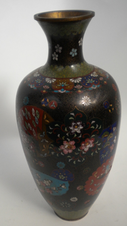 A tall tapering Japanese cloisonne vase with floral panel decoration, the flared neck with green