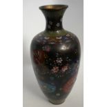 A tall tapering Japanese cloisonne vase with floral panel decoration, the flared neck with green