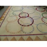 A large Couristan New Zealand wool carpet, the beige ground decorated with various Olympic style