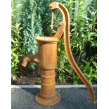 A cast metal rust effect ornamental garden water pump.