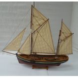 A wood model of a sailing Brixham trawler.