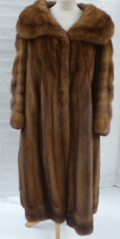 A full length wild mink coat, the silk lining monogrammed 'DS', two cardboard hat boxes and a