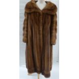 A full length wild mink coat, the silk lining monogrammed 'DS', two cardboard hat boxes and a