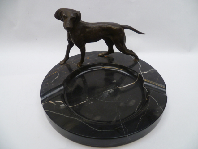 A well modelled bronze hunting dog raised on a black marble ashtray (vide de poche).