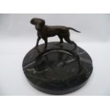 A well modelled bronze hunting dog raised on a black marble ashtray (vide de poche).