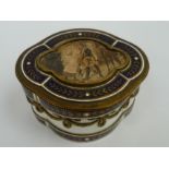 A Continental china serpentine shaped dressing table box with brass and enamel mounts and