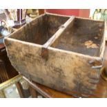 A wooden trug with integral carrying handle.