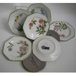 Six Italian Este octagonal floral decorated plates with green line painted rims bearing labels 'Made