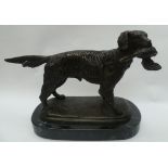 A contemporary cast bronze model of a retriever on black marble base.