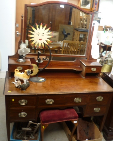 An Edwardian string inlaid mahogany dressing table with arched rectangular swing mirror over two