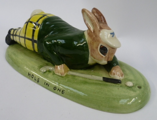 An Acorn china figurine depicting a golfing rabbit lying prone on a green base inscribed ''Hole in - Image 2 of 3