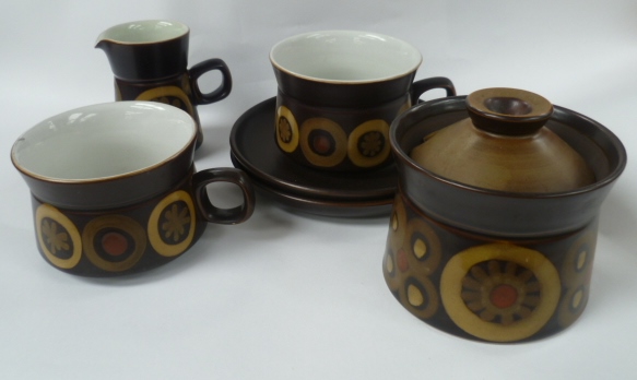 A pair of Denby 'Arabesque' coffee cups and saucers, a similar sugar bowl and cream jug, three glass