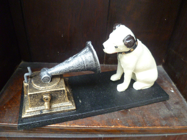 A reproduction cast metal HMV dog and gramophone ornament.