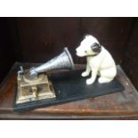 A reproduction cast metal HMV dog and gramophone ornament.